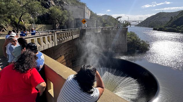 El Dique San Roque presenta su estado de agua por sobre el nivel del vertedero. Turistas mirando la cola de novia y el espectáculo del embudo. (La Voz)