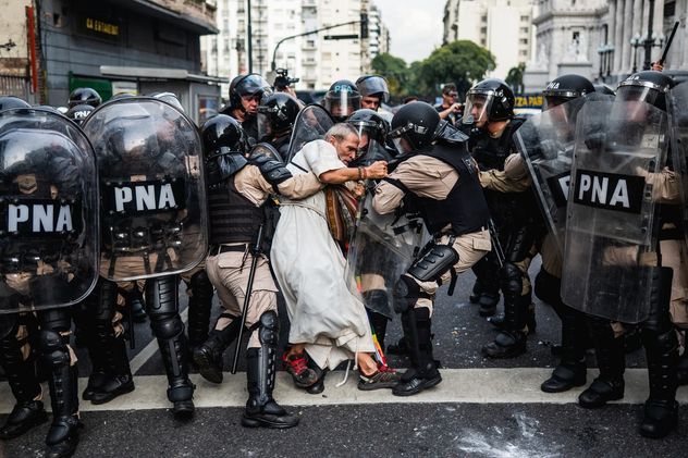 5-La policía detiene al padre Jorge “Chueco” Romero durante una protesta de jubilados en Buenos Aires, Argentina, durante una de las manifestaciones semanales contra la congelación de las pensiones y los recortes a la cobertura médica esencial.