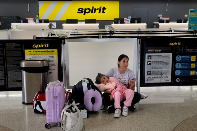 Vanessa Potosi y su hija de 4 años, Emiliana Cardona, esperan en el mostrador de facturación de Spirit Airlines tras la cancelación de su vuelo en el Aeropuerto Internacional de Fort Lauderdale-Hollywood el sábado 2 de mayo de 2026. (Mike Stocker /South Florida Sun-Sentinel vía AP)