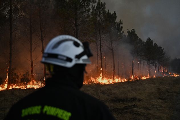 Bomberos combaten un incendio forestal que arrasa las cercanías de Le Las, en las afueras de Burdeos, Francia.