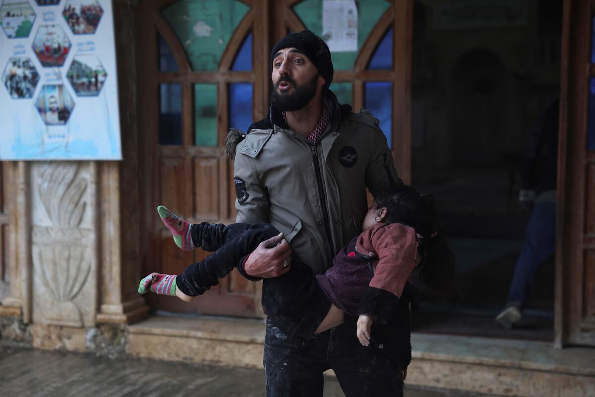 Un hombre sirio lleva a una niña muerta en la localidad de Azmarin, en la provincia de Idlib, en el norte de Siria. (AP Foto/Ghaith Alsayed)