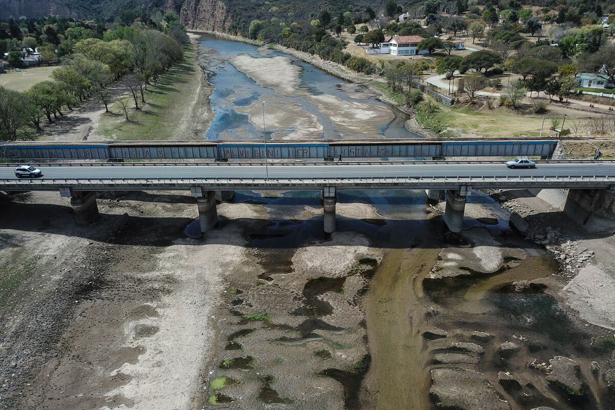 Por la escasez de agua, se decretó alerta naranja en Villa Carlos Paz. la toma aérea con dron muestra el Río Bialet Massé y del puente sobre el lago San Roque.
(La Voz)