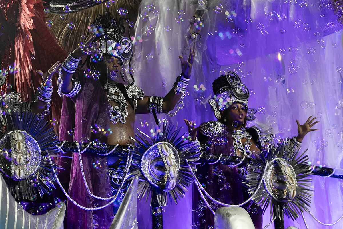 Artistas de la escuela de samba Unidos de Padre Miguel desfilan en una carroza. (AP)