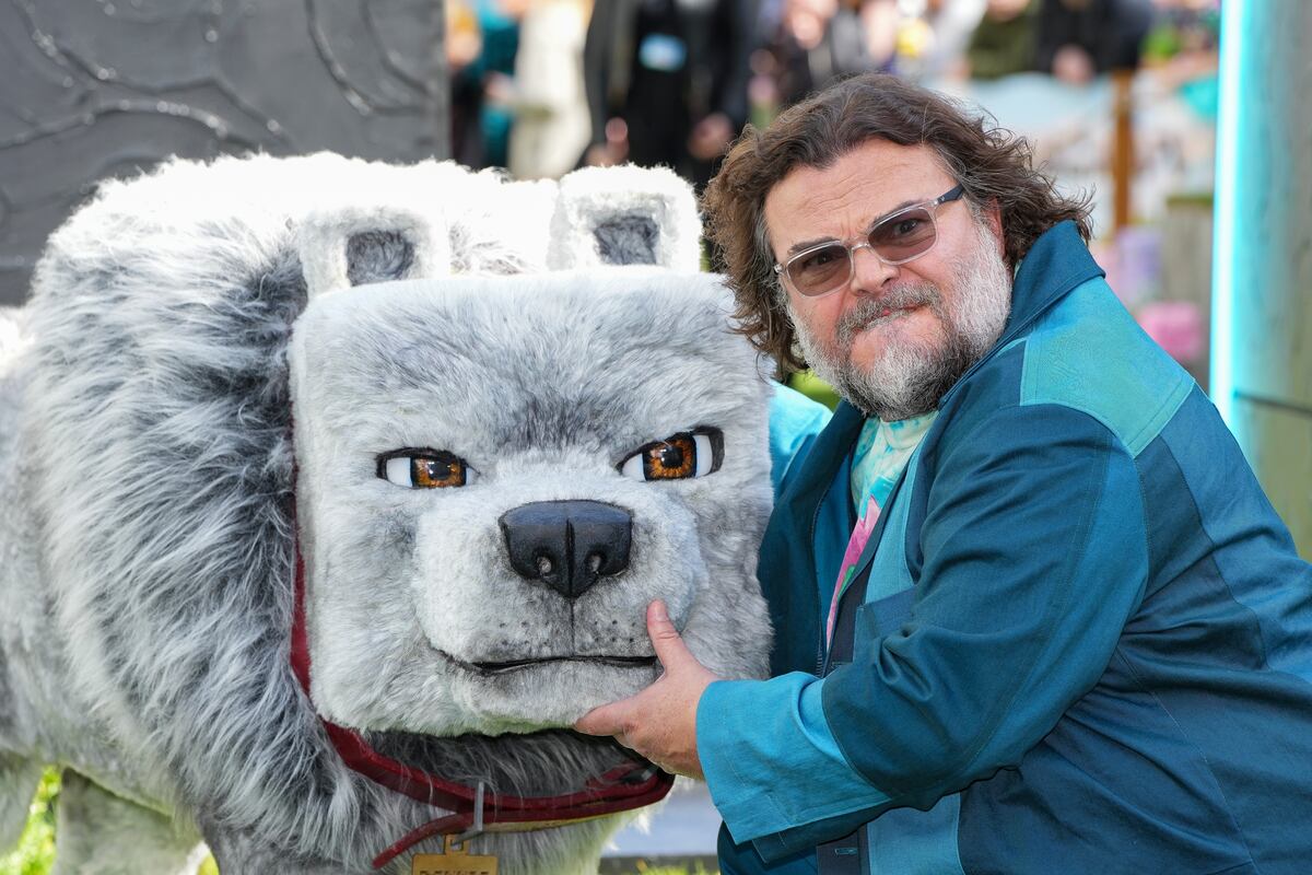 Jack Black posa para los fotógrafos con un modelo de personaje lobo de la película, a su llegada al estreno mundial de A Minecraft Movie el domingo 30 de marzo de 2025 en Londres. (Foto Scott A Garfitt/Invision/AP)