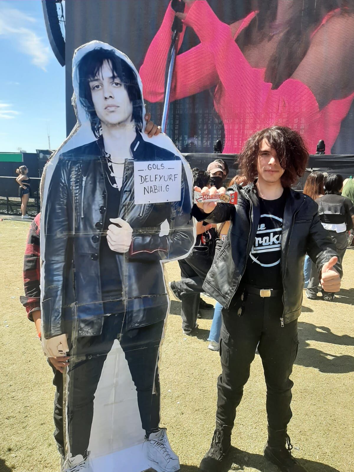 Fans de The Strokes en el Lollapalooza Argentina 2022, esperando a la banda. Con la gigantografía de Julian Casablancas y la golosina preferida del cantante (Foto La Voz)