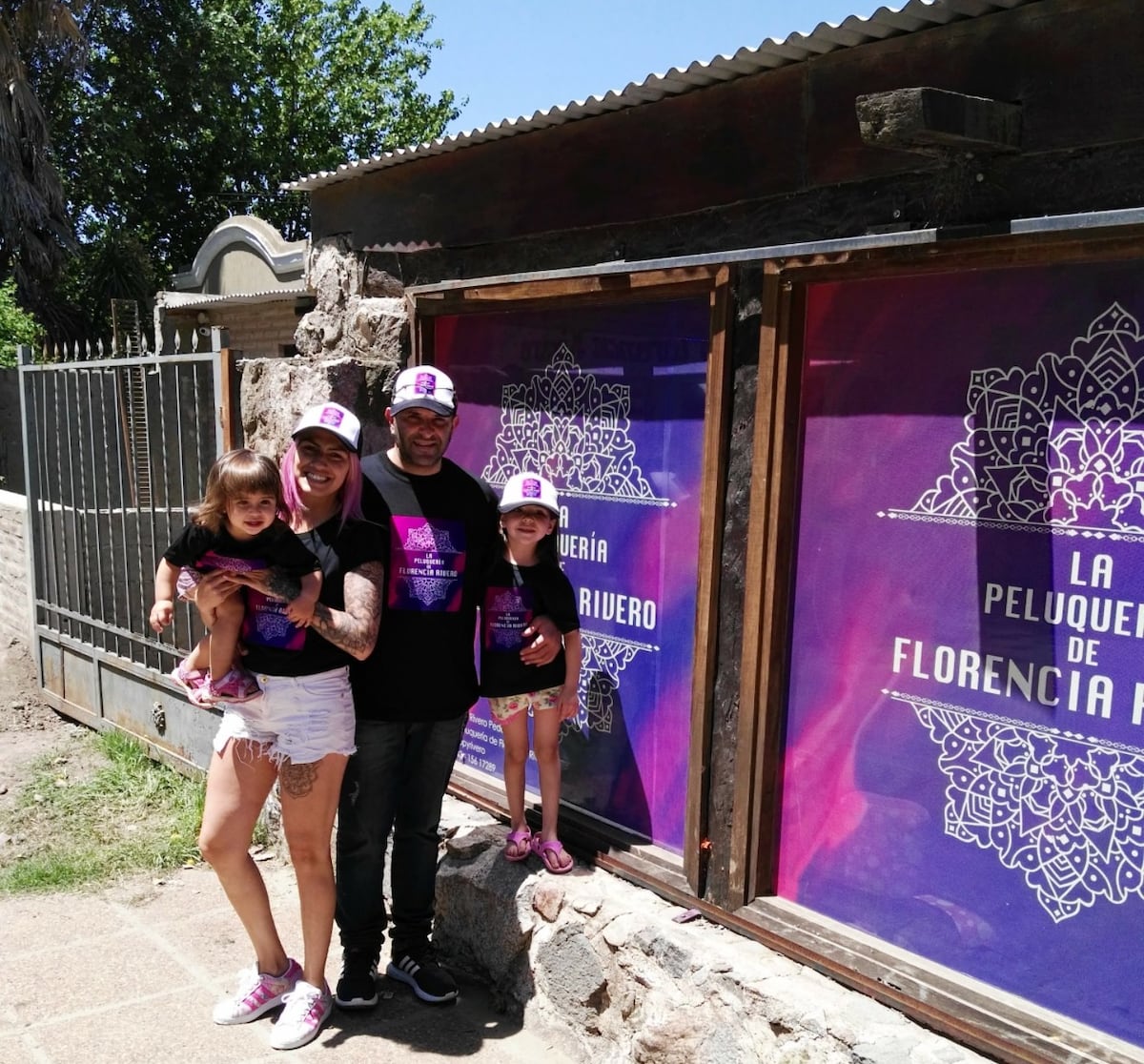 Todos los años, el ritual era cambiarle el ploteado. Acá, con otro color en la vidriera, con sus hijas y Daniel. (Gentileza)
